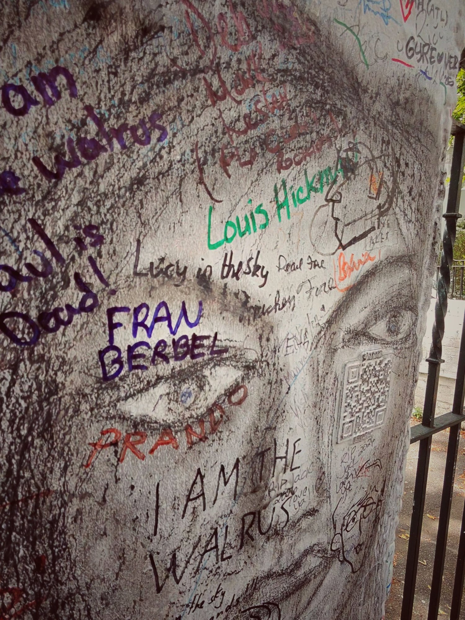 Graffiti-covered wall outside Abbey Road Studios reading I Am The Walrus