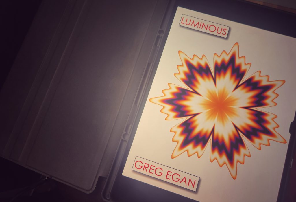 Greg Egan's short story collection Luminous displayed on a tablet screen in a folio case